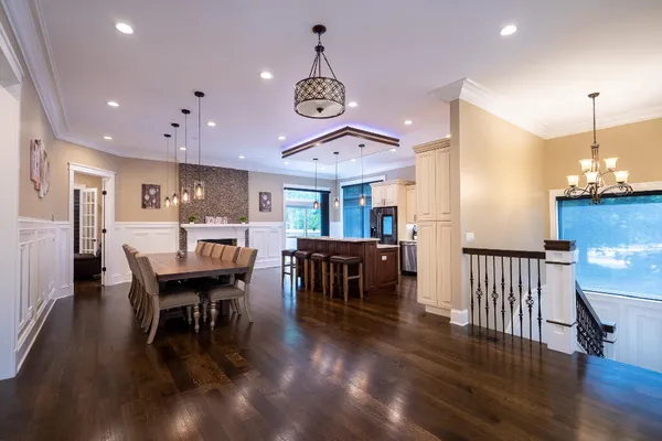 a large kitchen with stainless steel appliances a stove center island and a wooden floor