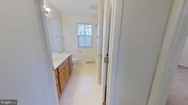 a view of a bathroom from a corridor