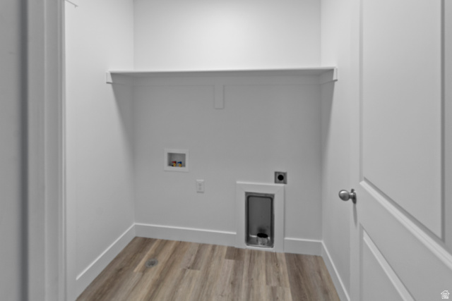 1264 West 500 South, Unit 320 Logan, UT 84321 - Photo 31 of 39 Dedicated laundry area featuring wood-finish flooring, a wall-mounted utility shelf, and white baseboards