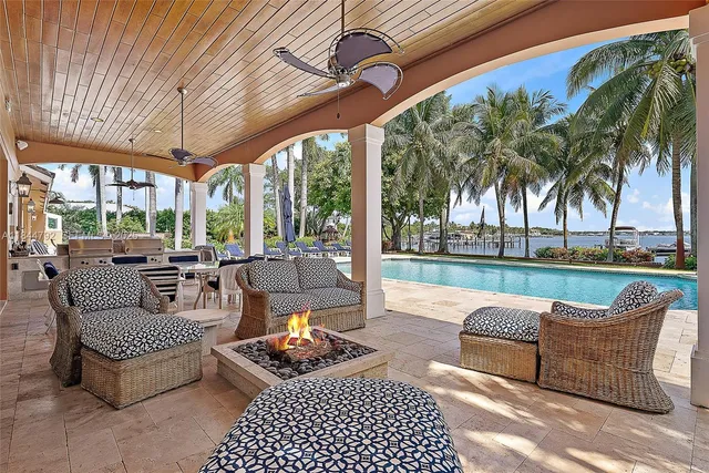 a room with lots of potted plants and a large window