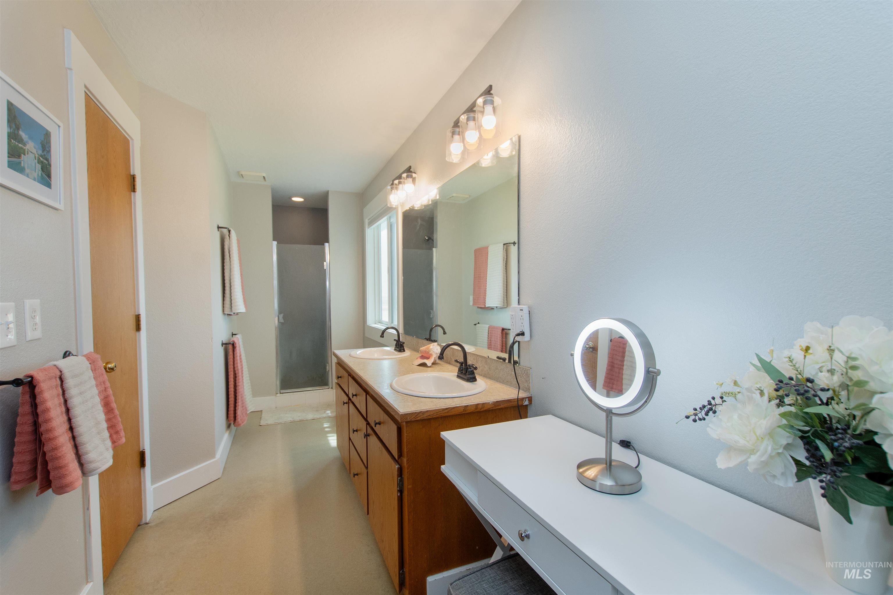 12369 Deer Flat Road Nampa, ID 83686 - Photo 33 of 50 Bedroom featuring a window with natural wood trim, light beige wall paint, a ceiling-mounted flush light fixture, and textured carpet flooring