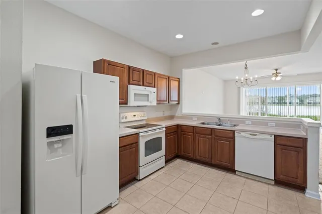 a kitchen with stainless steel appliances granite countertop a refrigerator sink and stove