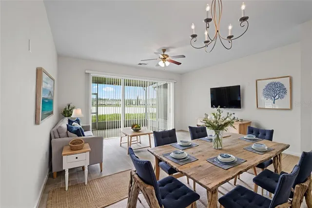 a view of a dining room with furniture wooden floor and a chandelier