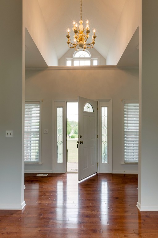 3501 Greens Mill Road Spring Hill, TN 37174 - Photo 3 of 16 a view of an empty room with chandelier and wooden floor