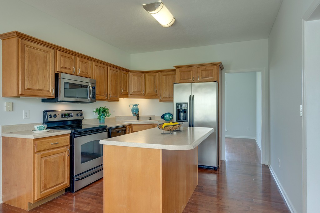3501 Greens Mill Road Spring Hill, TN 37174 - Photo 6 of 16 a kitchen with stainless steel appliances granite countertop a refrigerator stove microwave and sink