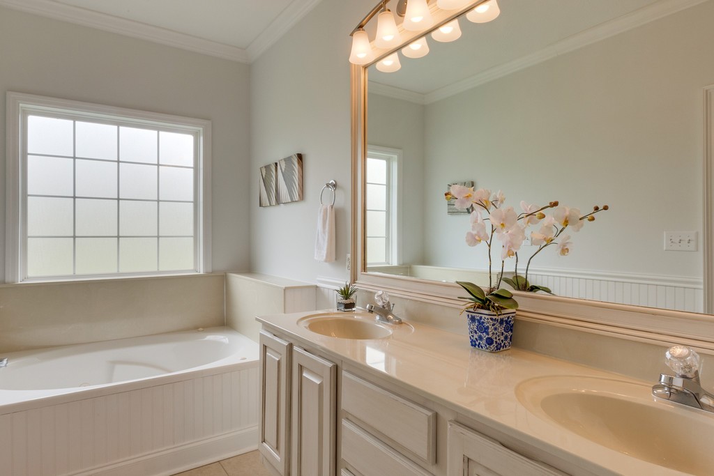 3501 Greens Mill Road Spring Hill, TN 37174 - Photo 9 of 16 a bathroom with a tub sink and mirror