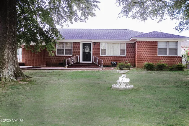 a front view of a house with a yard table and chairs
