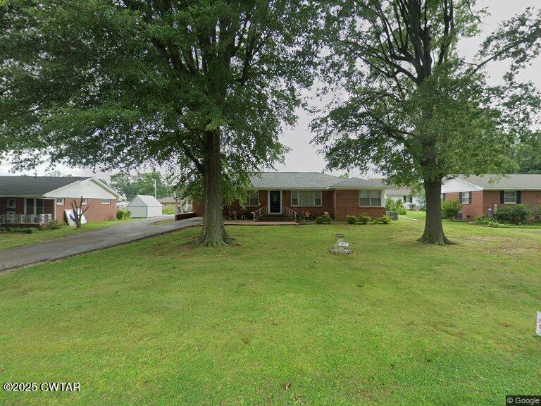 209 Hillside Street Kenton, TN 38233 - Photo 2 of 43 a front view of a house with a garden