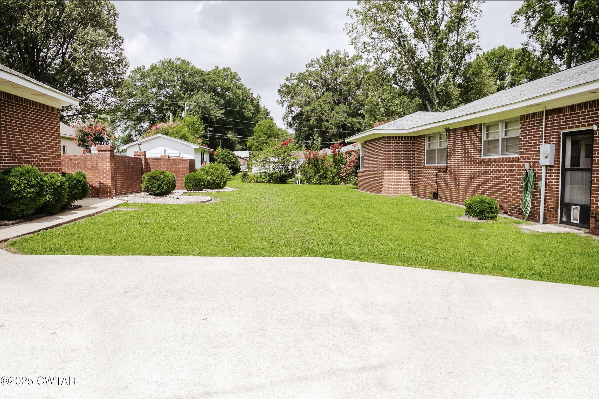 209 Hillside Street Kenton, TN 38233 - Photo 3 of 43 a view of backyard with a garden and trees