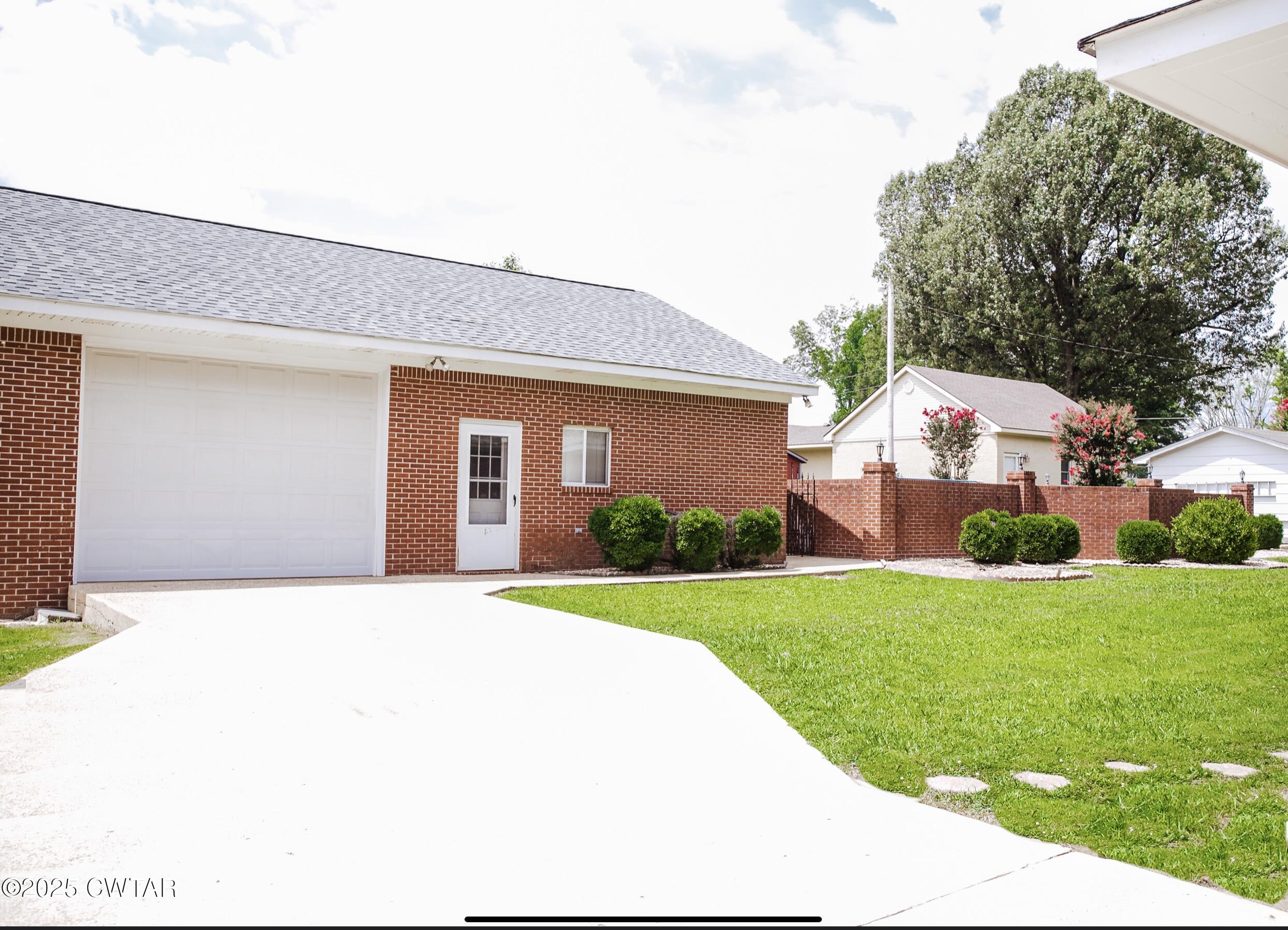 209 Hillside Street Kenton, TN 38233 - Photo 6 of 43 a front view of a house with garden