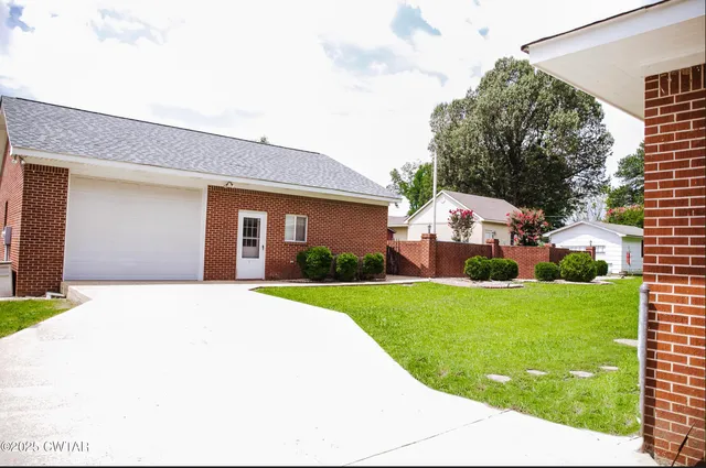 a view of a kitchen with an empty space and wooden floor