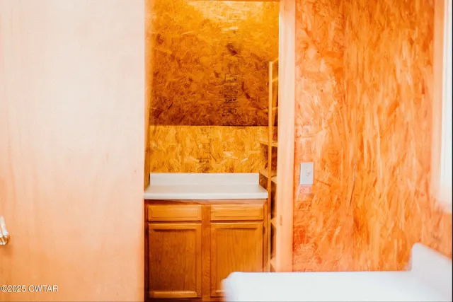a view of a kitchen with wooden floor and a sink