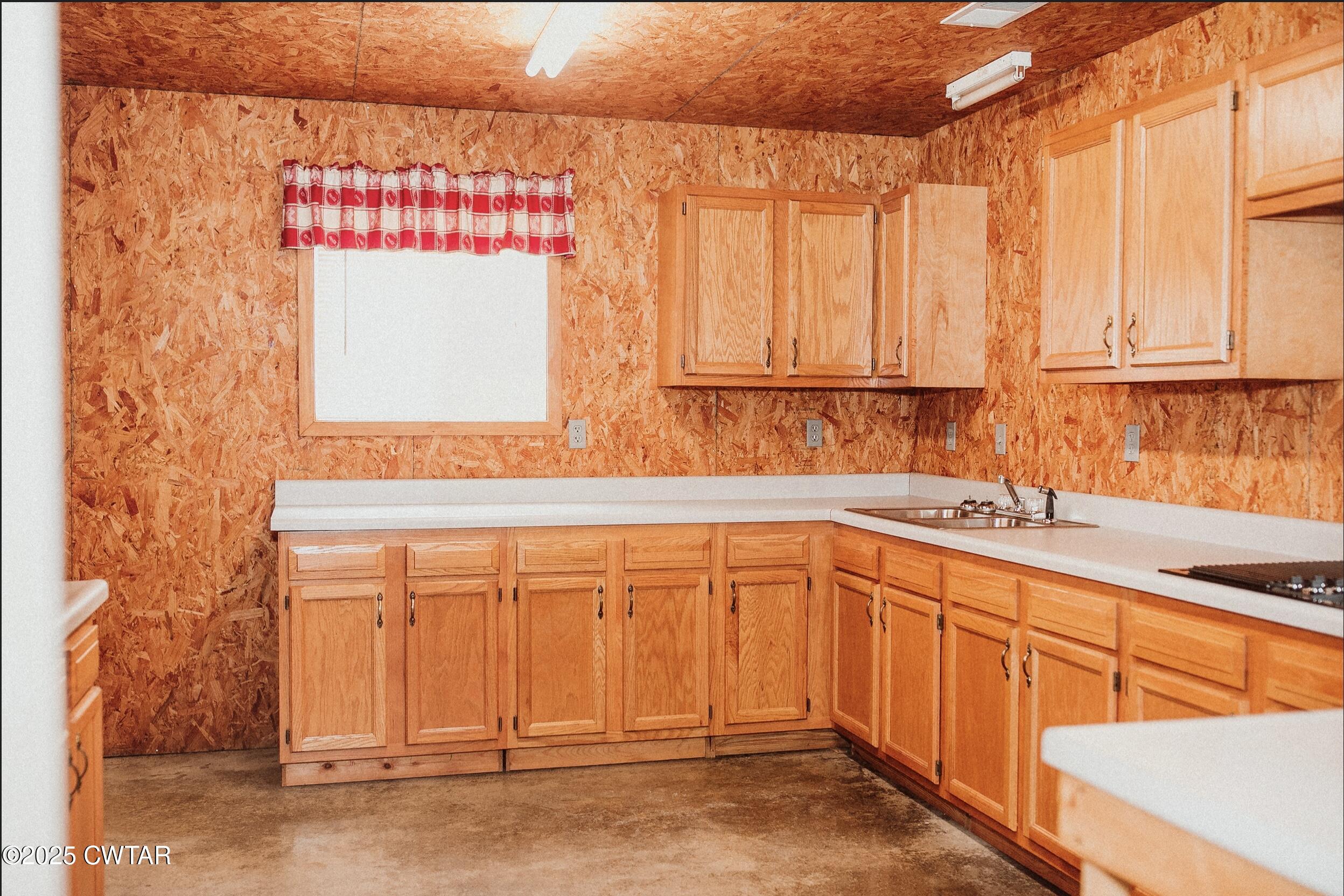 209 Hillside Street Kenton, TN 38233 - Photo 9 of 43 a kitchen with stainless steel appliances granite countertop a sink and cabinets