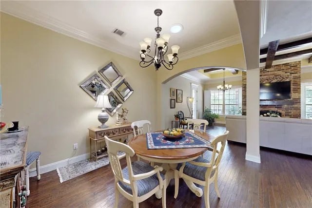 a view of a dining room with furniture wooden floor and chandelier