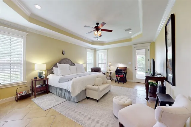 a bedroom with bed couch and window