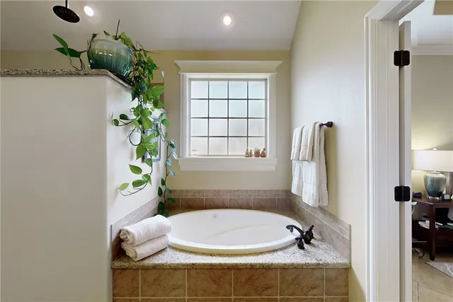 a bathroom with a tub and shower