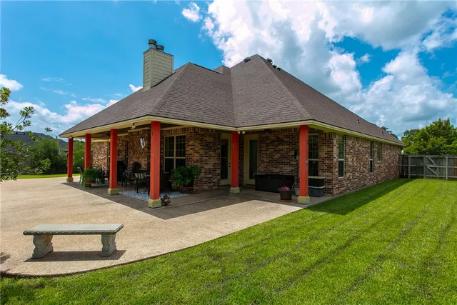 a view of a house with a yard and porch