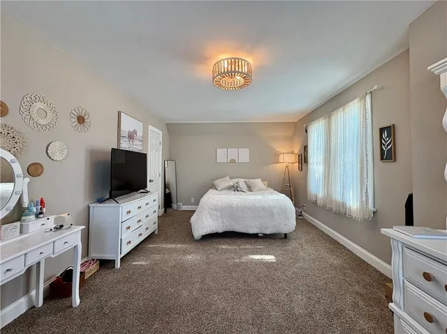 a bedroom with furniture and a flat screen tv