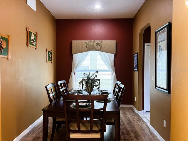 a living room with furniture and floor to ceiling windows