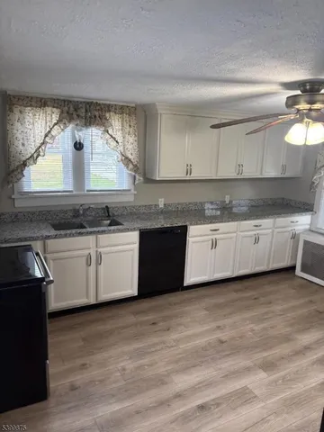 a kitchen with stainless steel appliances granite countertop a sink and cabinets