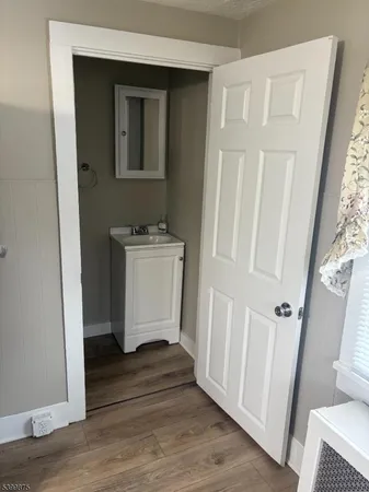 a room with a window and wooden floor