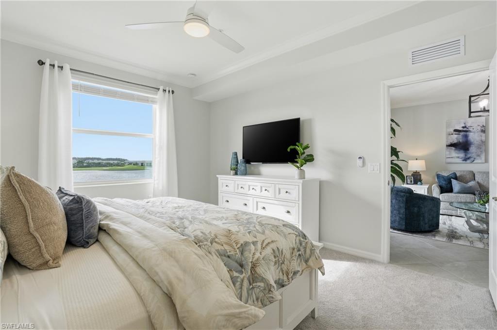 5555 Double Eagle Circle, Unit 3935 Ave Maria, FL 34142 - Photo 16 of 49 a bedroom with a bed and flat tv screen on the dresser