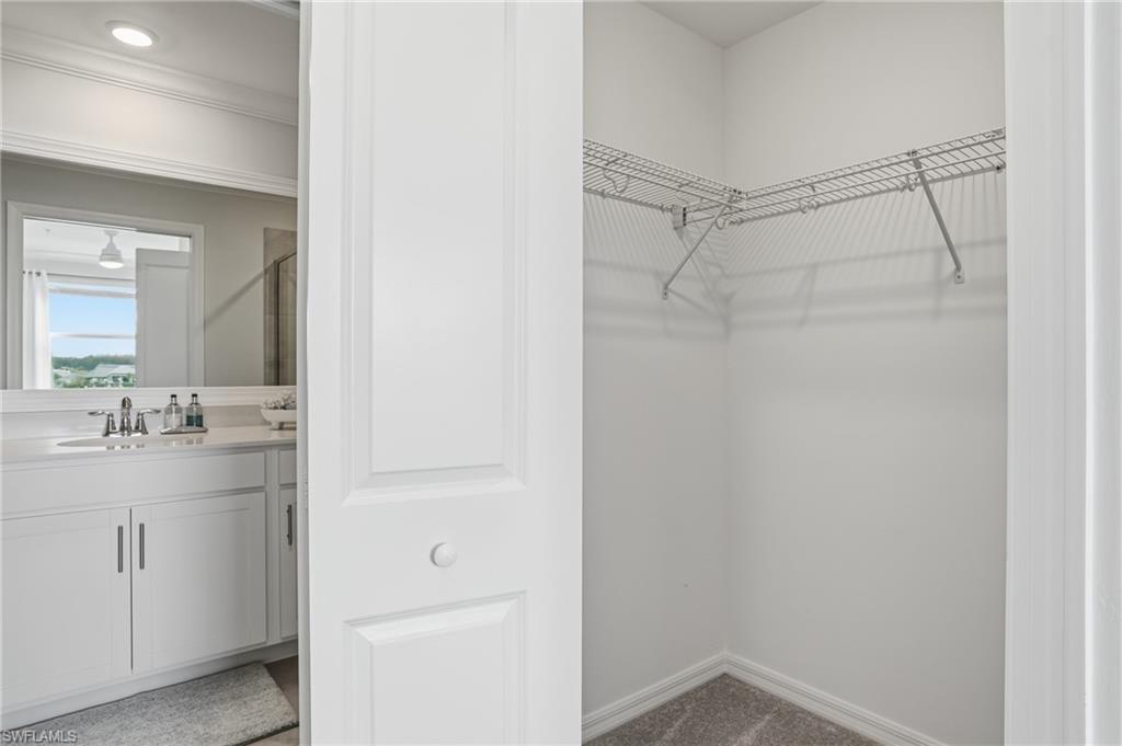 5555 Double Eagle Circle, Unit 3935 Ave Maria, FL 34142 - Photo 20 of 49 a bathroom with a shower sink vanity and mirror