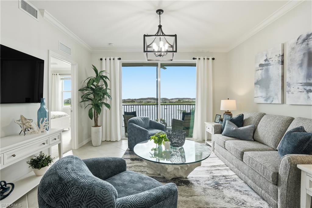5555 Double Eagle Circle, Unit 3935 Ave Maria, FL 34142 - Photo 2 of 49 a living room with furniture and a flat screen tv