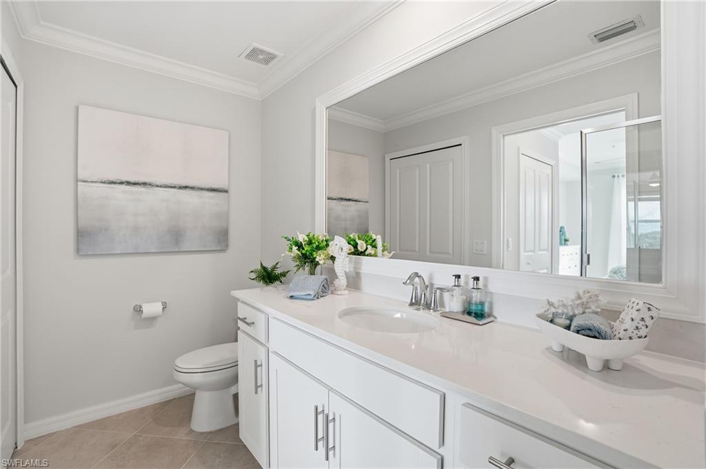 5555 Double Eagle Circle, Unit 3935 Ave Maria, FL 34142 - Photo 21 of 49 a bathroom with a granite countertop sink and a mirror