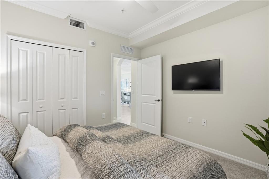 5555 Double Eagle Circle, Unit 3935 Ave Maria, FL 34142 - Photo 23 of 49 a bedroom with a bed and a television