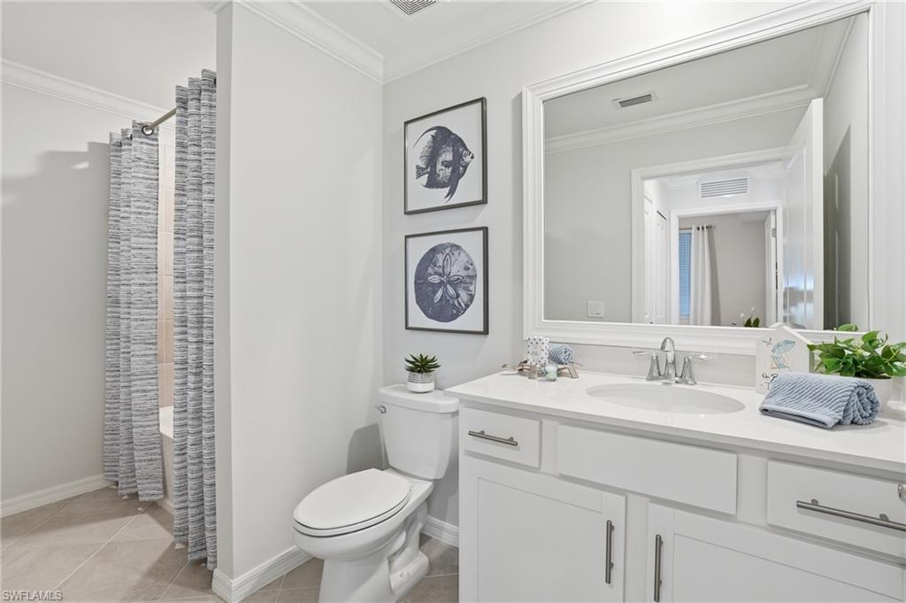 5555 Double Eagle Circle, Unit 3935 Ave Maria, FL 34142 - Photo 24 of 49 a bathroom with a toilet a sink and a mirror