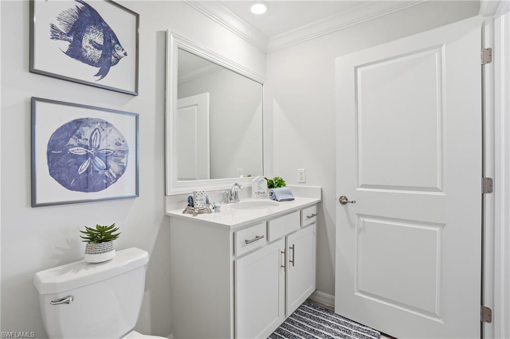 5555 Double Eagle Circle, Unit 3935 Ave Maria, FL 34142 - Photo 26 of 49 a bathroom with a toilet a sink and a mirror