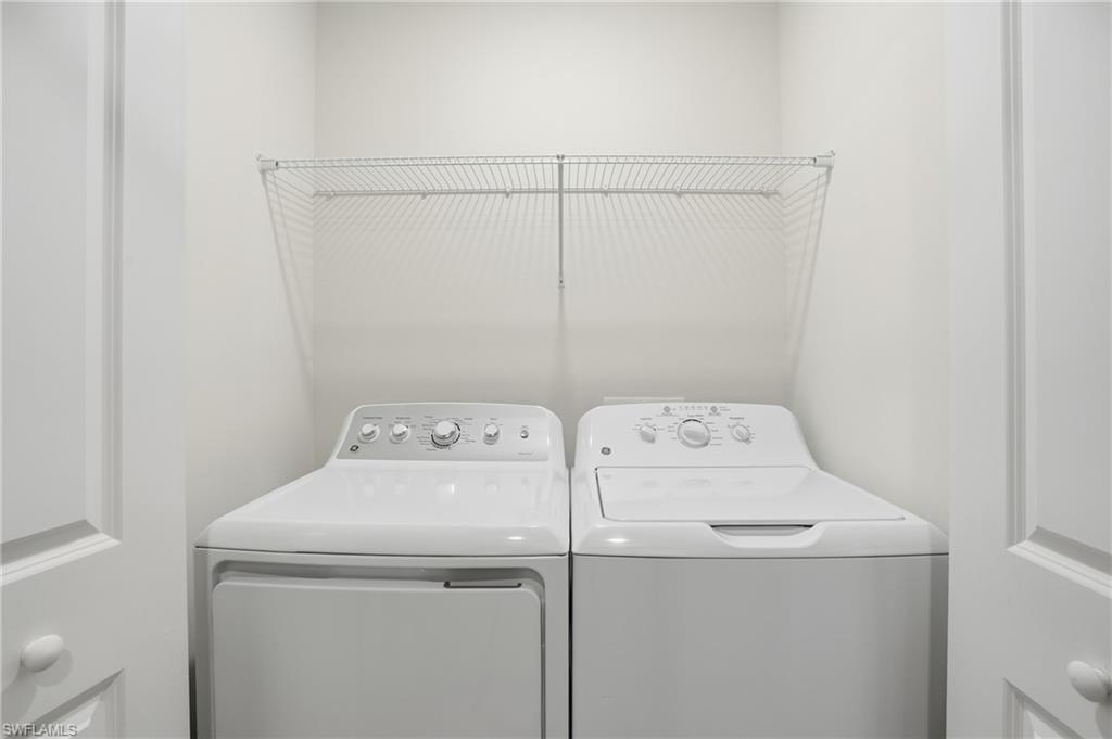 5555 Double Eagle Circle, Unit 3935 Ave Maria, FL 34142 - Photo 27 of 49 a utility room with dryer and washer