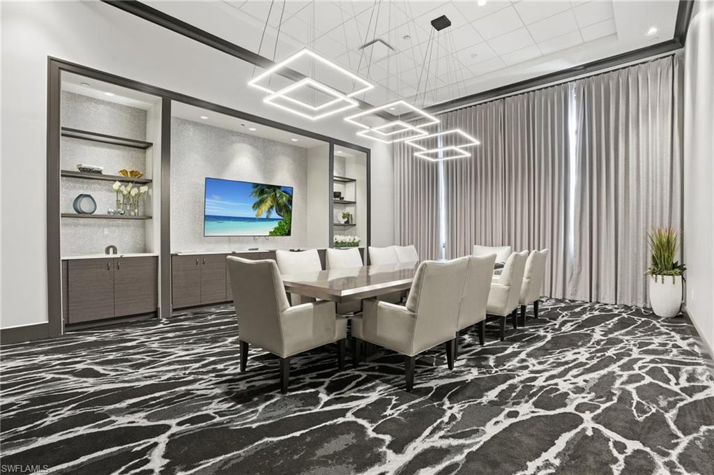 5555 Double Eagle Circle, Unit 3935 Ave Maria, FL 34142 - Photo 37 of 49 a living room with furniture and a chandelier