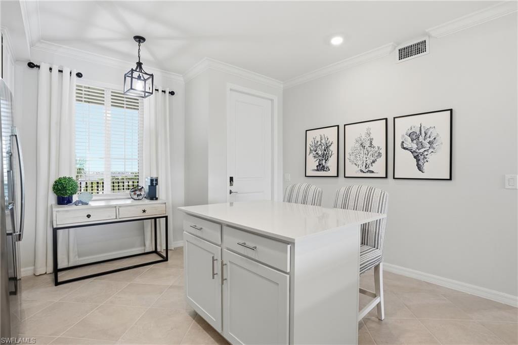 5555 Double Eagle Circle, Unit 3935 Ave Maria, FL 34142 - Photo 7 of 49 a kitchen with a sink and white cabinets