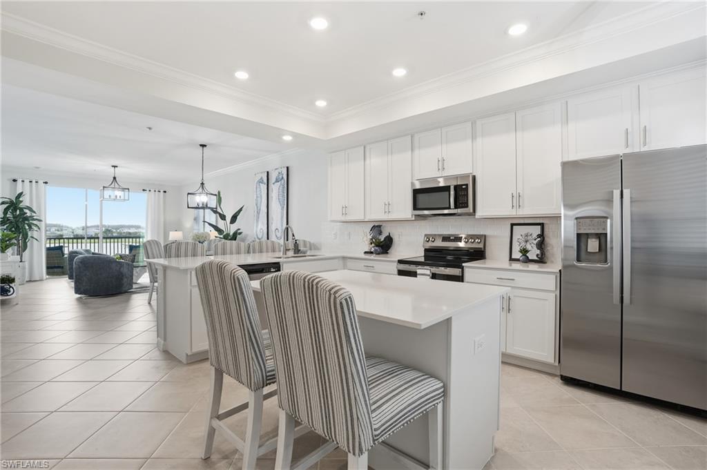5555 Double Eagle Circle, Unit 3935 Ave Maria, FL 34142 - Photo 8 of 49 a kitchen with stainless steel appliances a refrigerator and a stove top oven