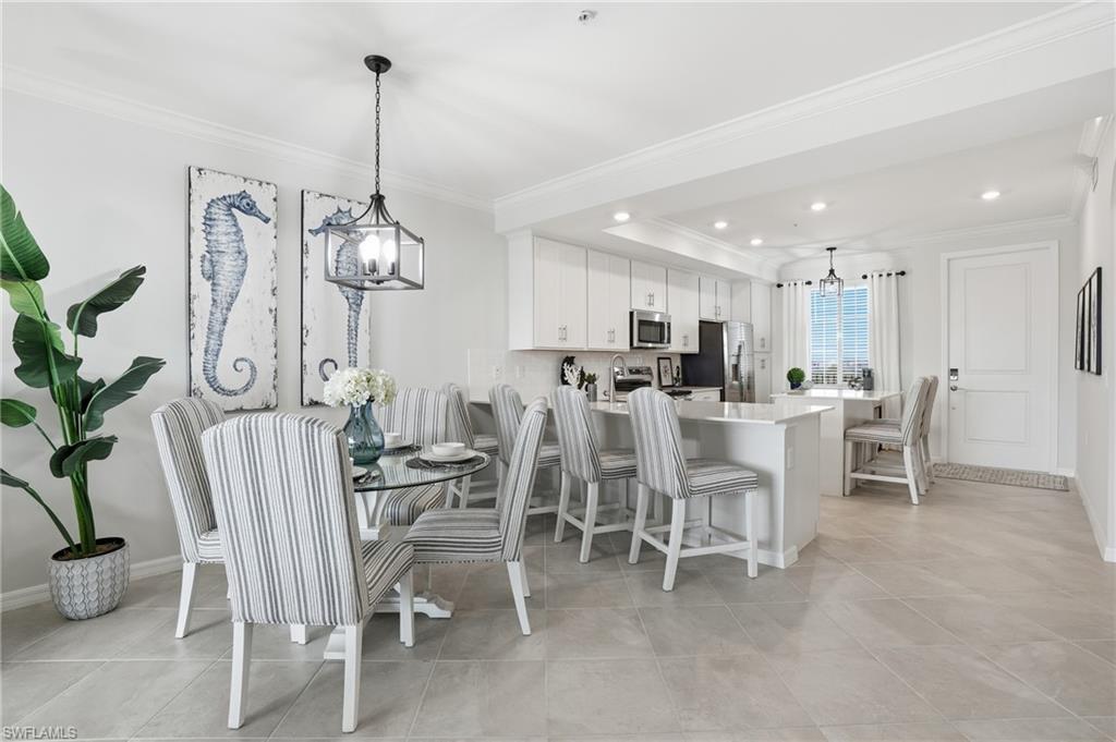 5555 Double Eagle Circle, Unit 3935 Ave Maria, FL 34142 - Photo 9 of 49 a view of a dining room and livingroom with furniture a chandelier