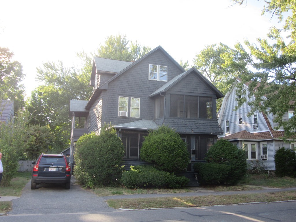 50-52 Dwight Road Springfield, MA 01108 - Photo 1 of 24 a front view of a house with a garden