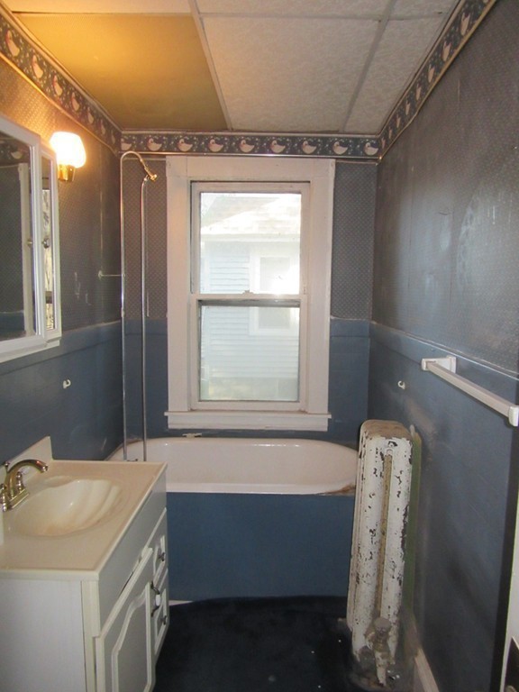 50-52 Dwight Road Springfield, MA 01108 - Photo 12 of 24 a bathroom with a tub sink vanity and a mirror