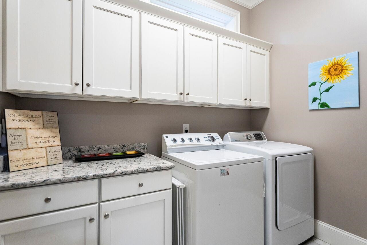 8401 Bournemouth Drive Raleigh, NC 27615 - Photo 23 of 41 Laundry Room with base/wall cabinets, granite tops, laundry chute and tile floors. Laundry Room