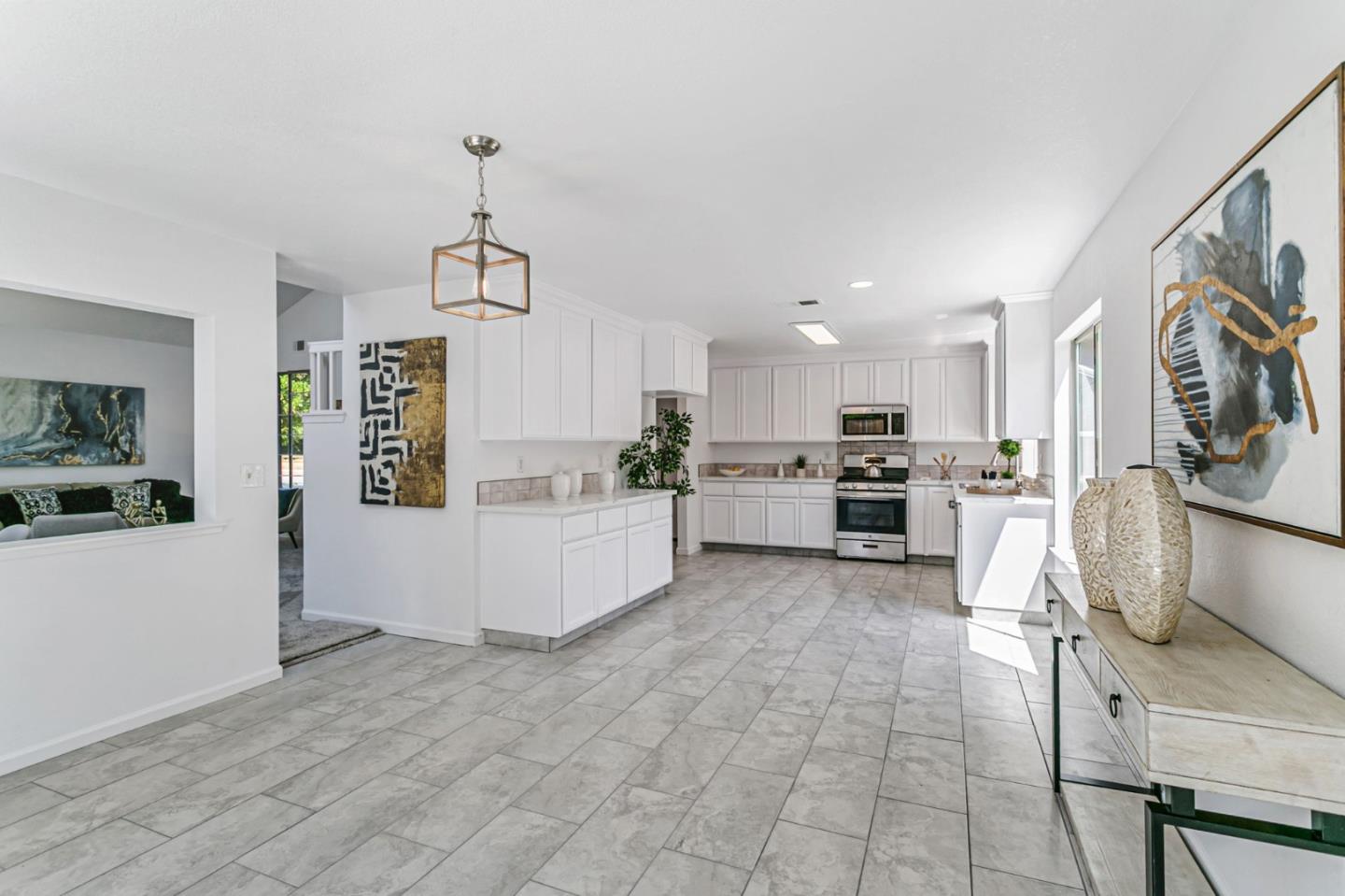 770 Babbs Creek Drive Gilroy, CA 95020 - Photo 11 of 39 a kitchen with stainless steel appliances granite countertop a refrigerator sink and white cabinets