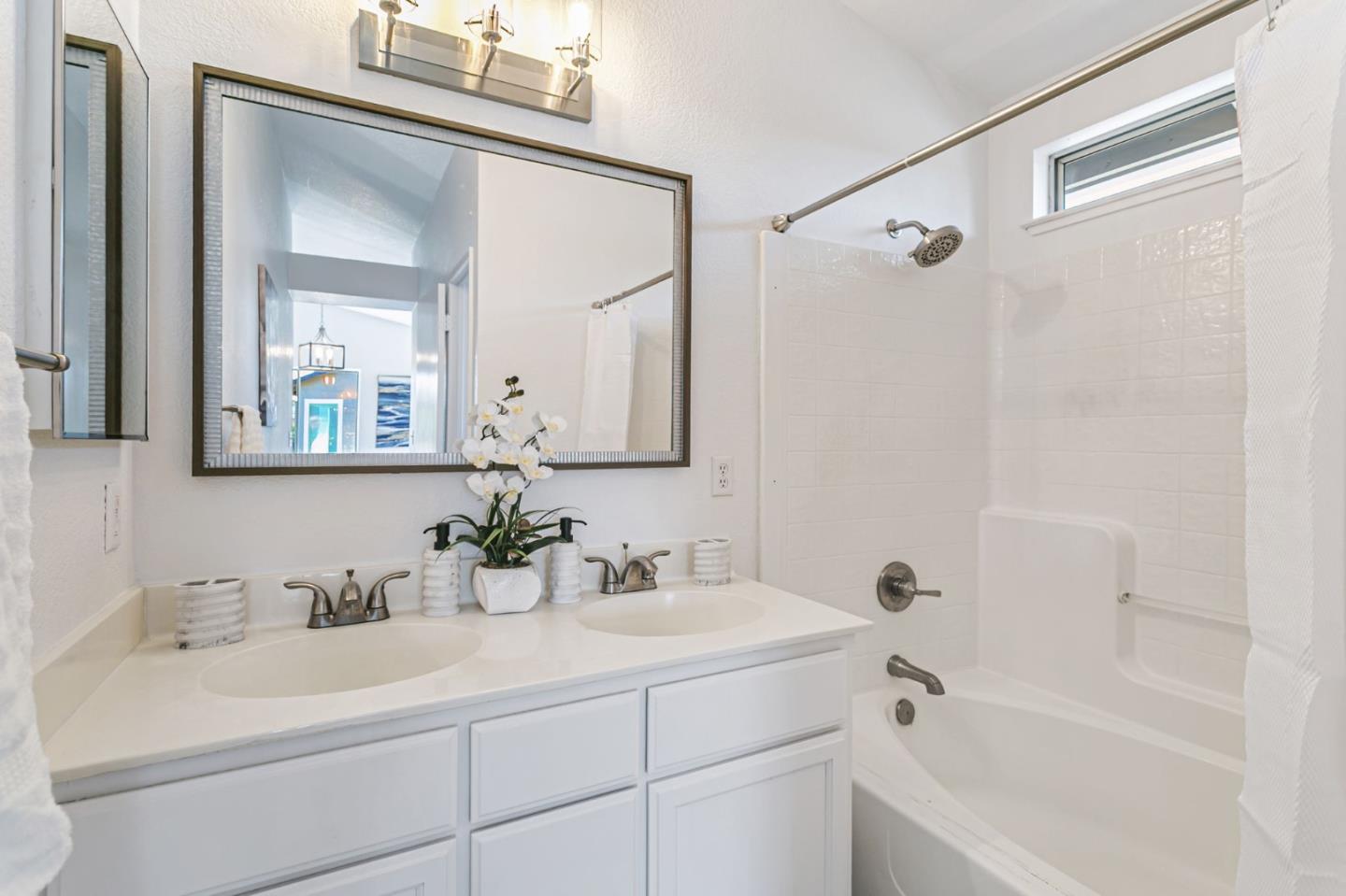 770 Babbs Creek Drive Gilroy, CA 95020 - Photo 32 of 39 a bathroom with a sink double vanity mirror and a bathtub