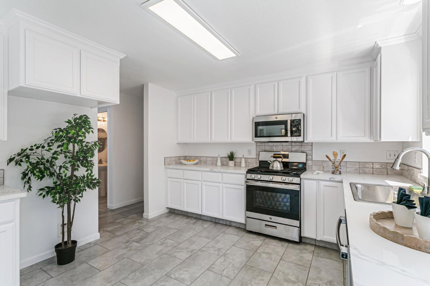 770 Babbs Creek Drive Gilroy, CA 95020 - Photo 9 of 39 a kitchen with a white stove top oven and white cabinets