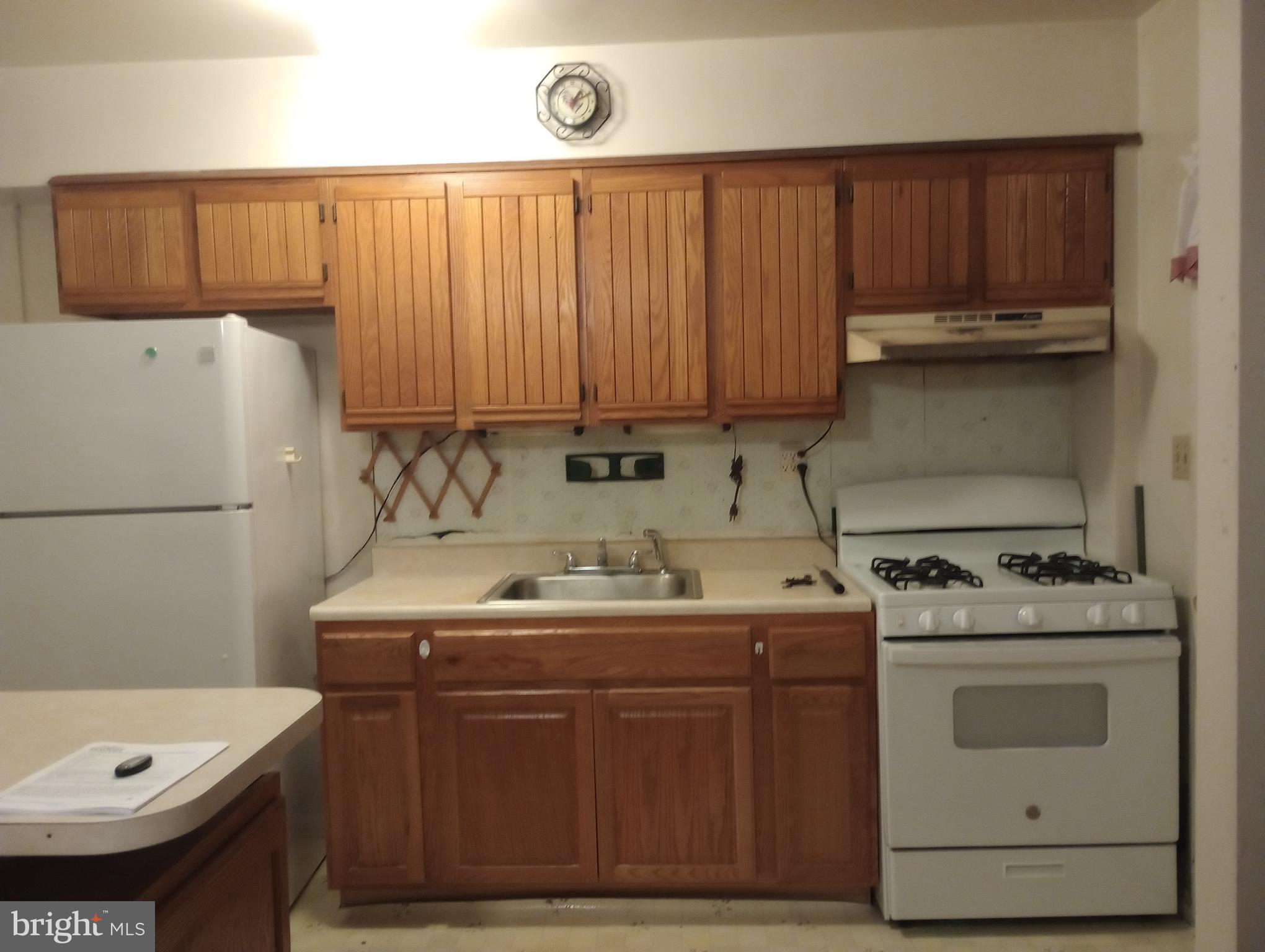 7527 Westfield Road Dundalk, MD 21222 - Photo 5 of 5 a kitchen with a sink a stove and cabinets
