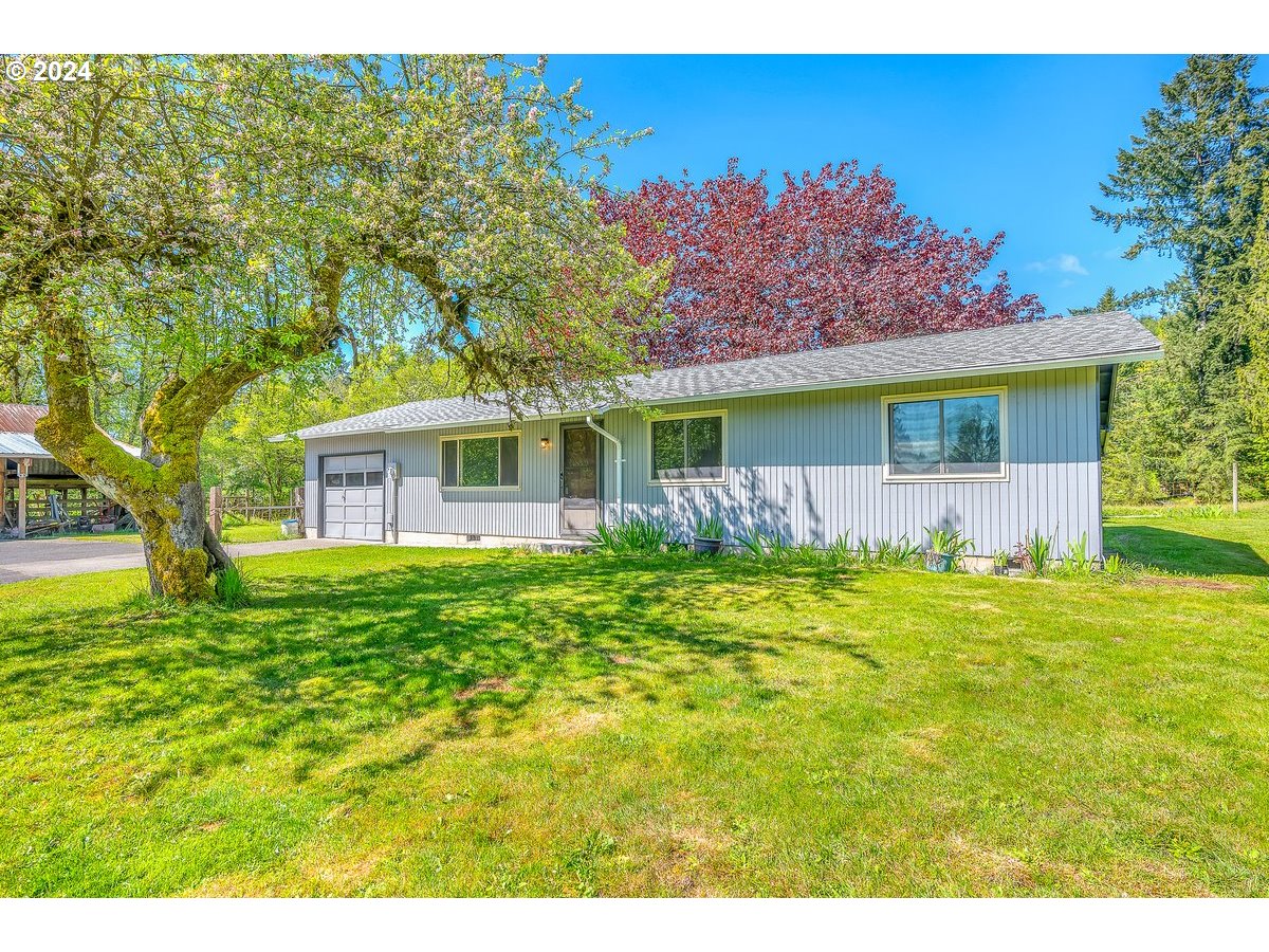 69711 Marcott Road Rainier, OR 97048 - Photo 3 of 18 a front view of a house with a garden