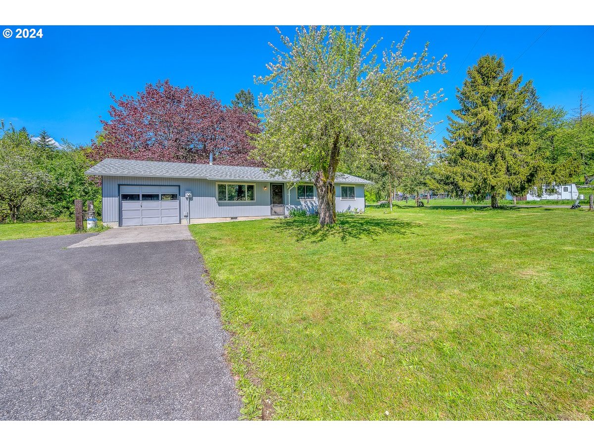 69711 Marcott Road Rainier, OR 97048 - Photo 4 of 18 a view of a house with a big yard