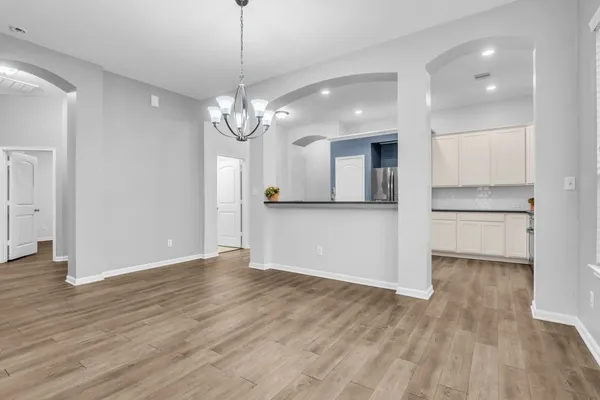 a view of a kitchen with wooden floor and a kitchen space