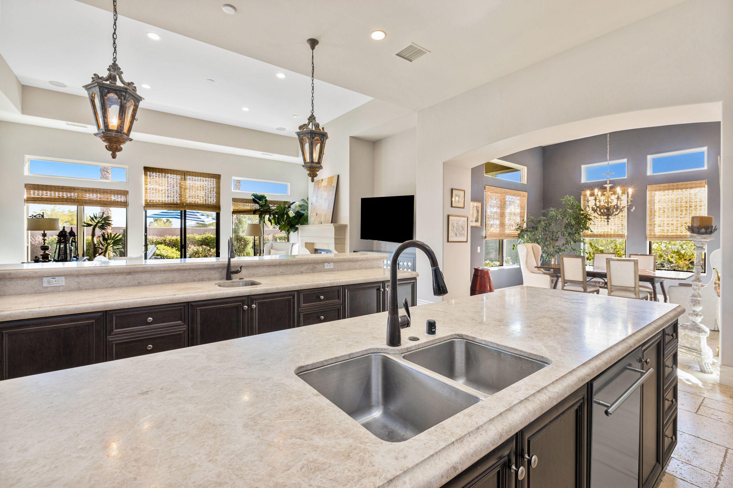 54360 Alysheba Drive La Quinta, CA 92253 - Photo 11 of 24 a kitchen with counter top a sink and a large window