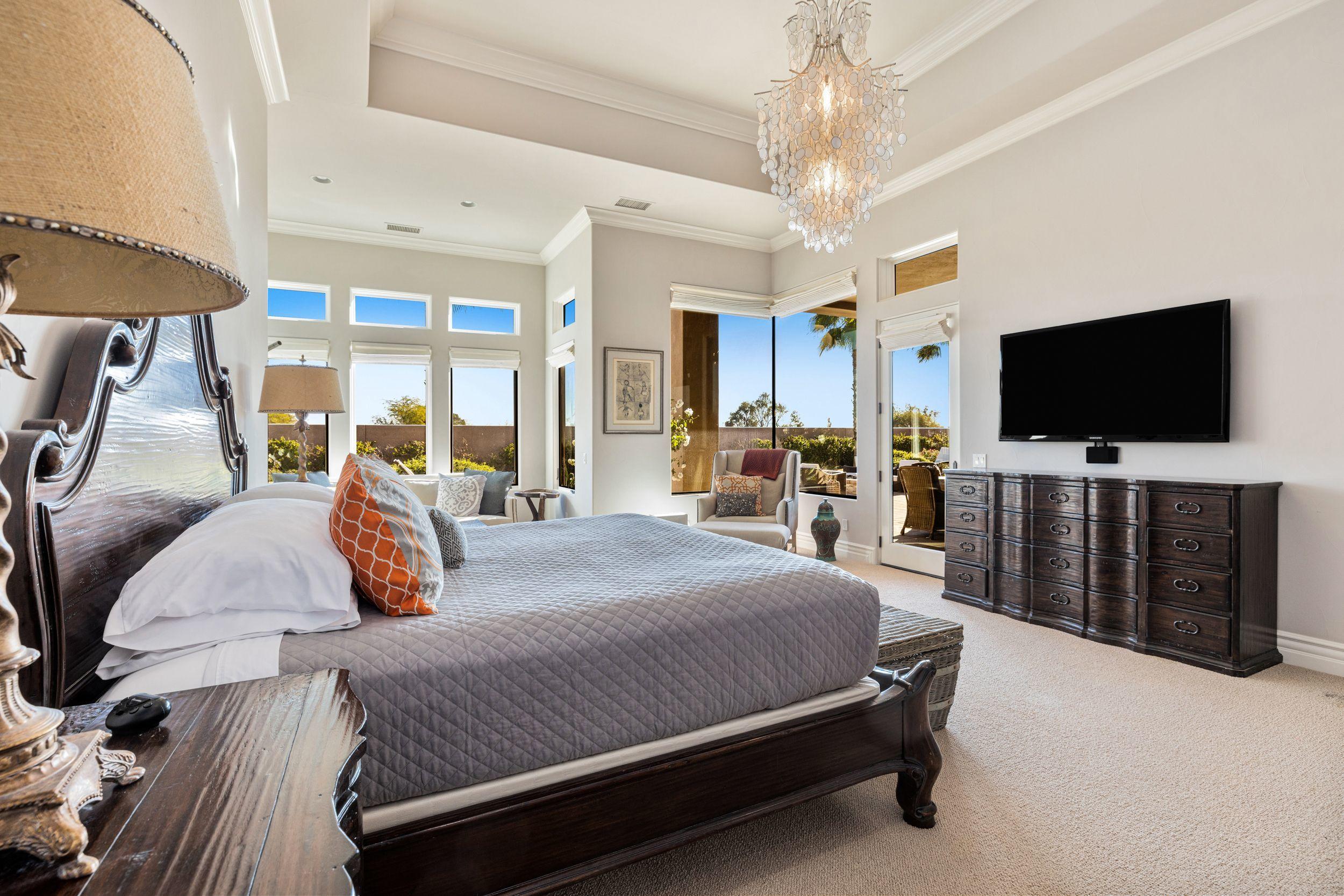 54360 Alysheba Drive La Quinta, CA 92253 - Photo 12 of 24 a bedroom with a bed and a flat tv screen on the dresser