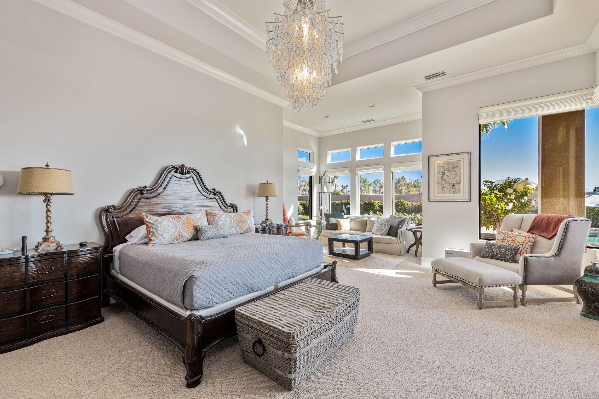 54360 Alysheba Drive La Quinta, CA 92253 - Photo 13 of 24 a bedroom with a bed couch and large window